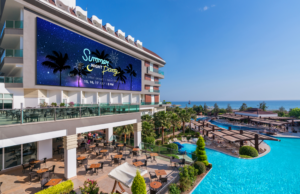 An LG large digital display outside a resort and casino, showcasing vibrant content, provided by LG Fulfilment for enhanced guest experiences.